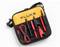 A yellow and black bag with the inscription 'FLUKE' contains several red and black measuring accessories.