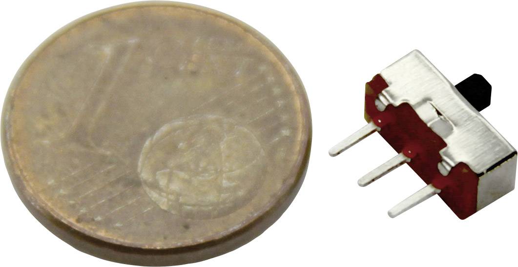 'Small toggle switch next to a one-cent coin, showing the switch's size in comparison to the coin.'