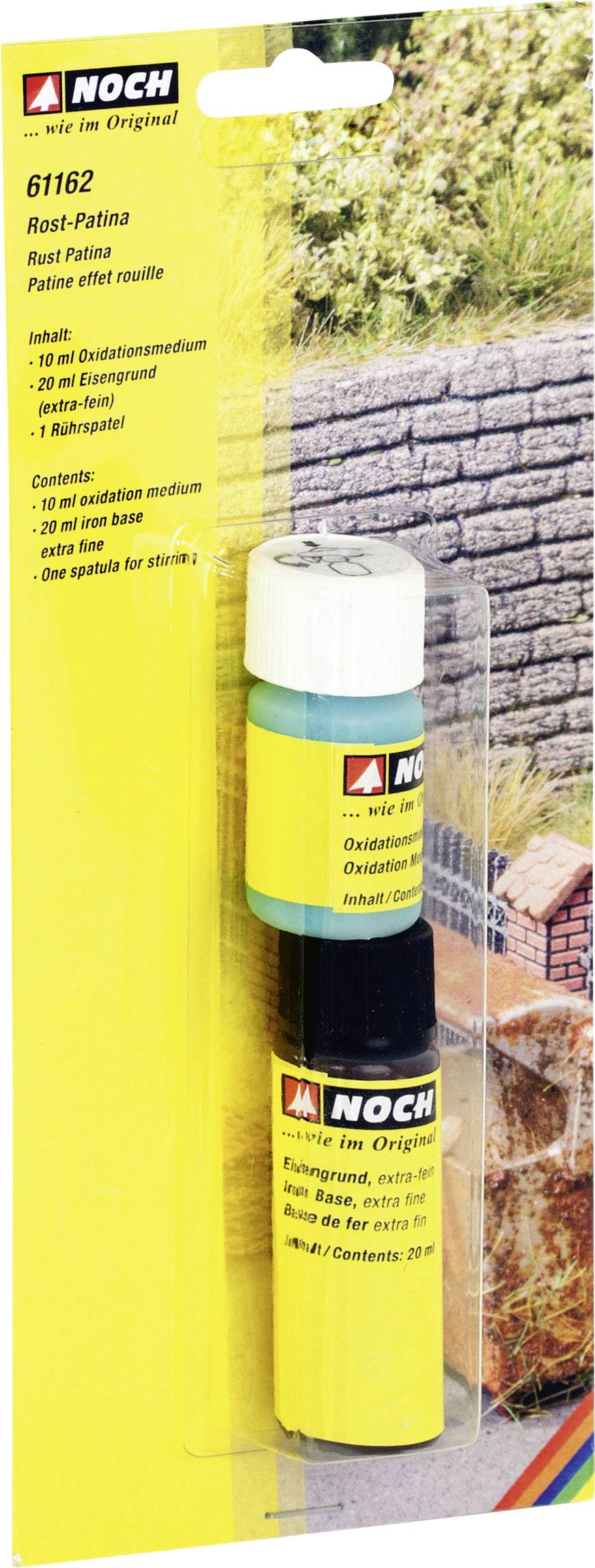 'Rust Patina Set' consisting of two bottles in one package, used for ageing model-making objects. In the background, a miniature stone wall.