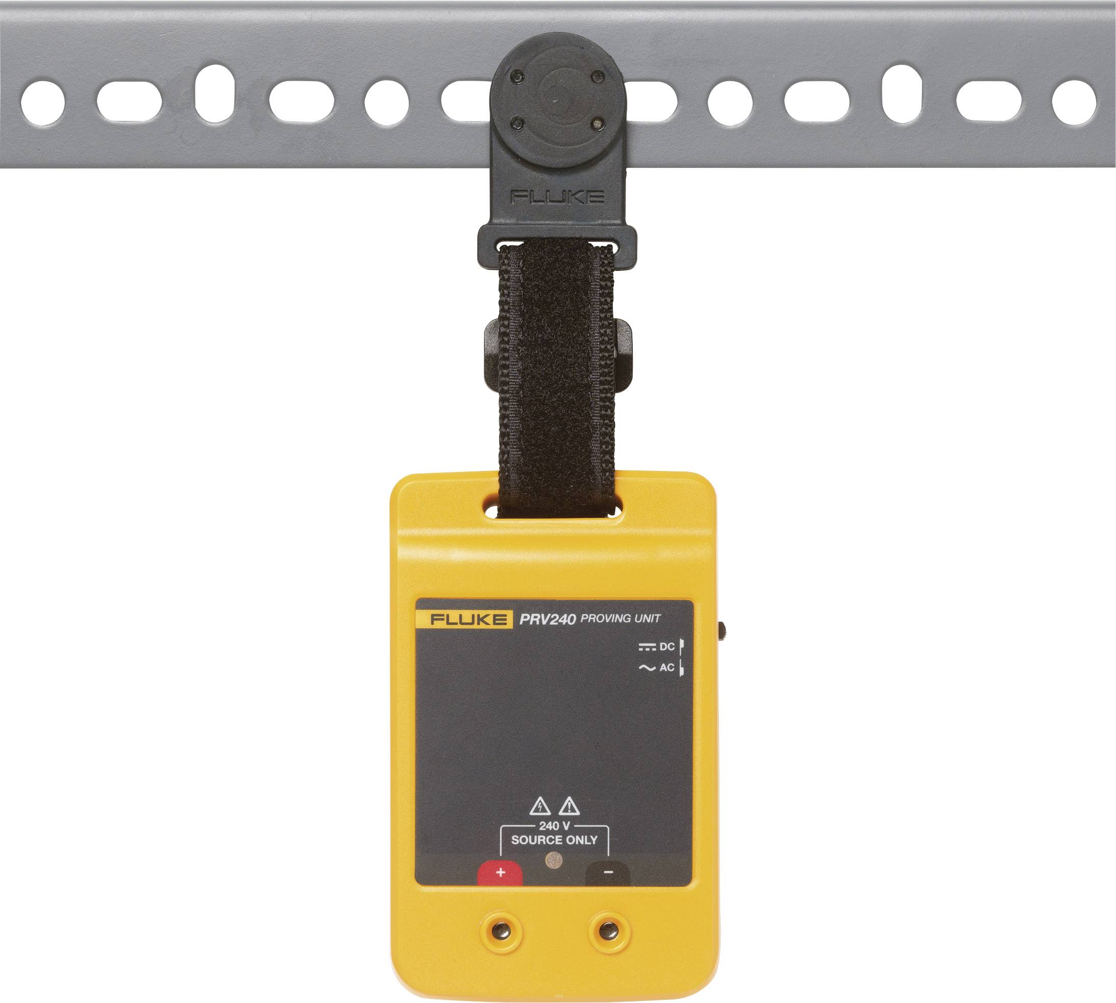 A yellow electrical testing device hanging from a grey metal pole. It has a display on the front.
