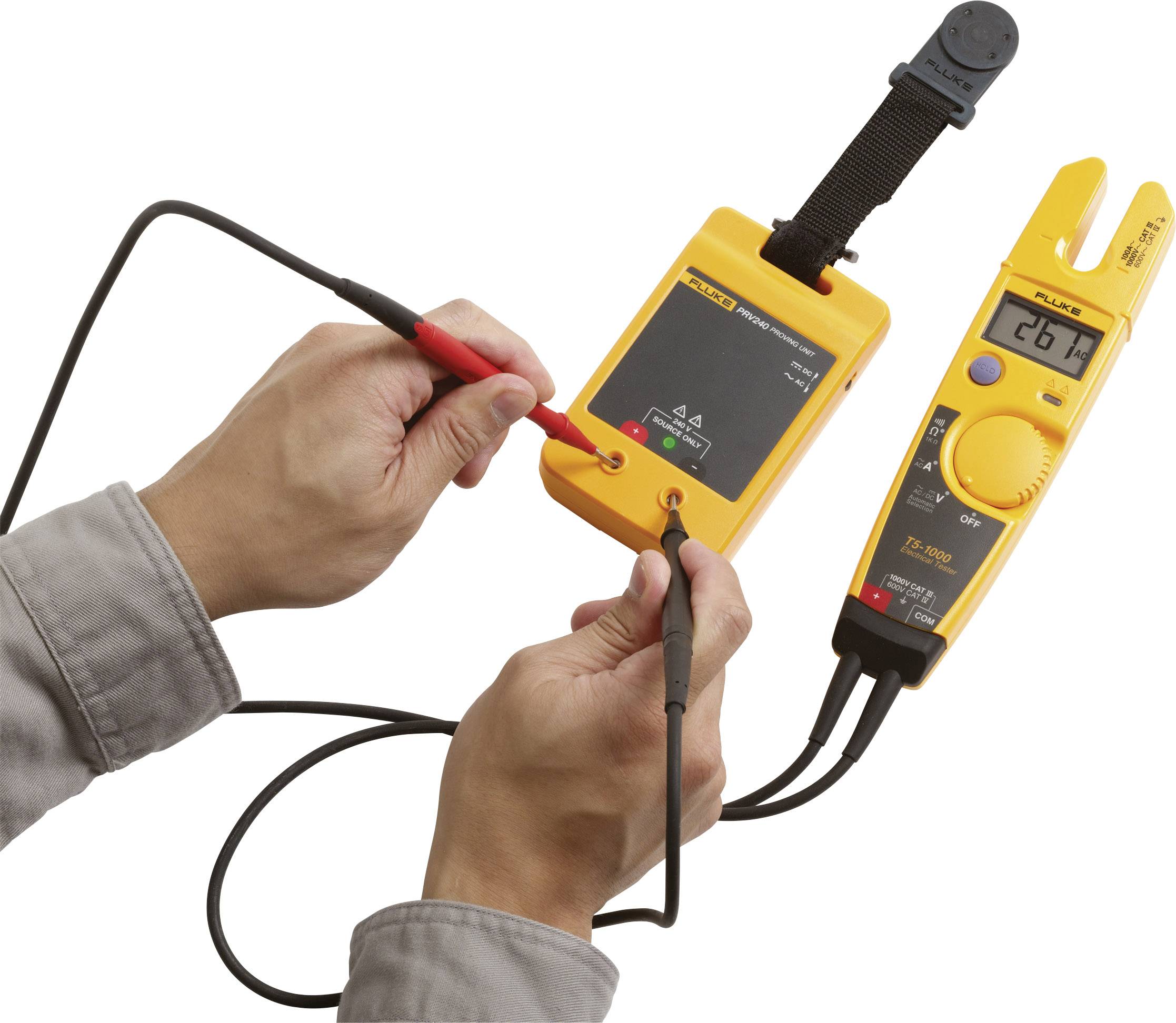 A person is using an electrical testing device with a yellow casing. The display shows a number that likely represents a measurement result.