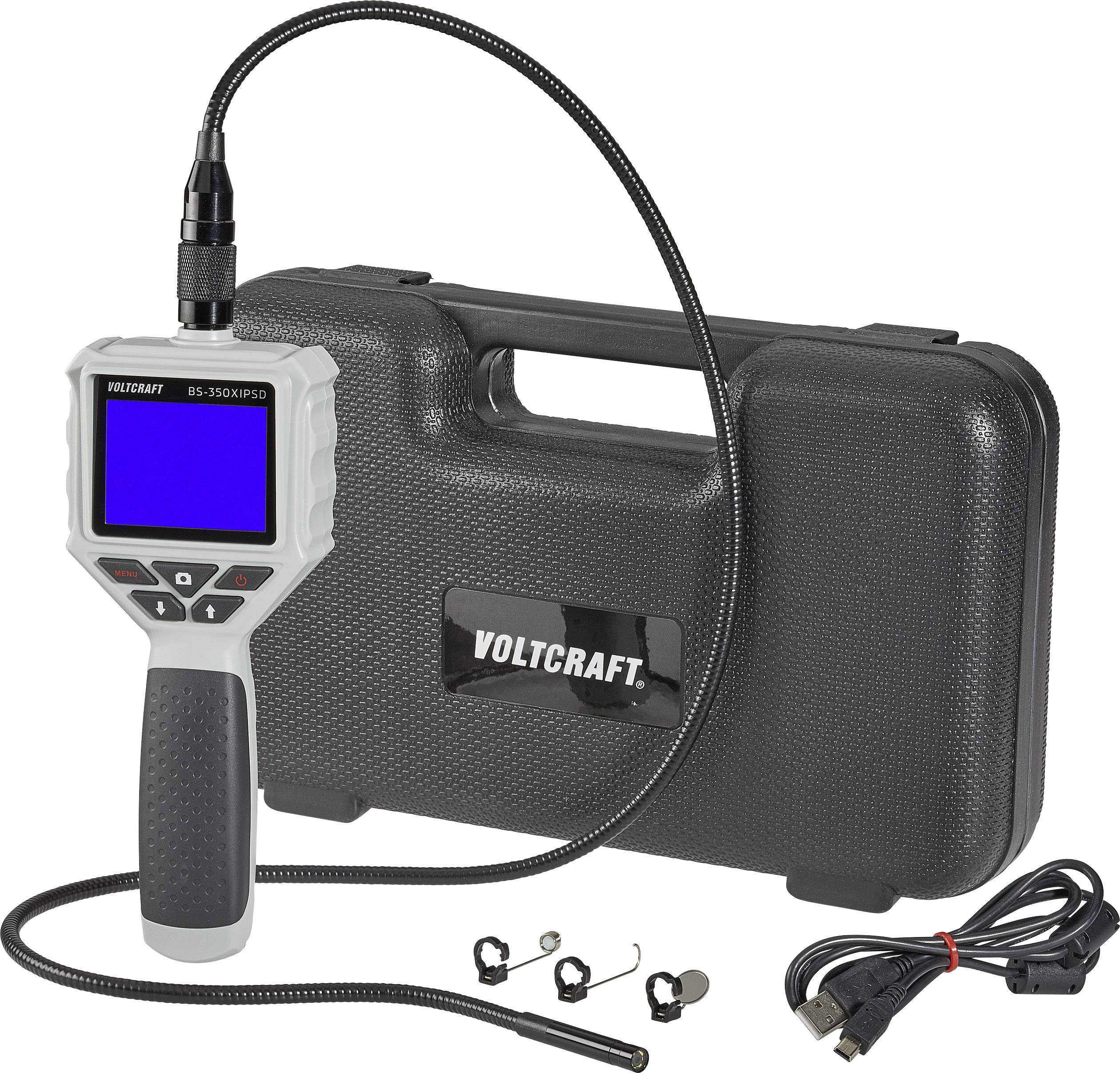 Endoscope camera with flexible cable, LCD display and control buttons. In the background, a black carrying case with 'Voltcraft'.