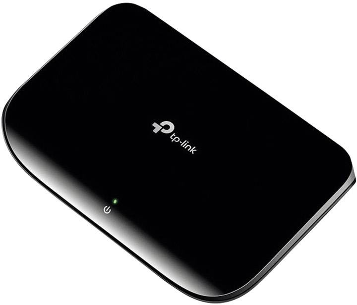 Black, rectangular mobile router by TP-Link. A green light illuminates from the top.
