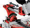 Saw blade of a red and silver mitre saw, tilting to the left or right. Angle indicator and adjustment lever are visible.