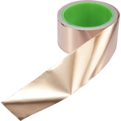 Roll of shiny copper foil with a green inner core, wound up and partially unrolled, material for electrical engineering or crafts.