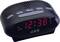 A digital alarm clock with a red LED display shows the time as 12:38. Buttons for alarm functions and radio are located at the top.