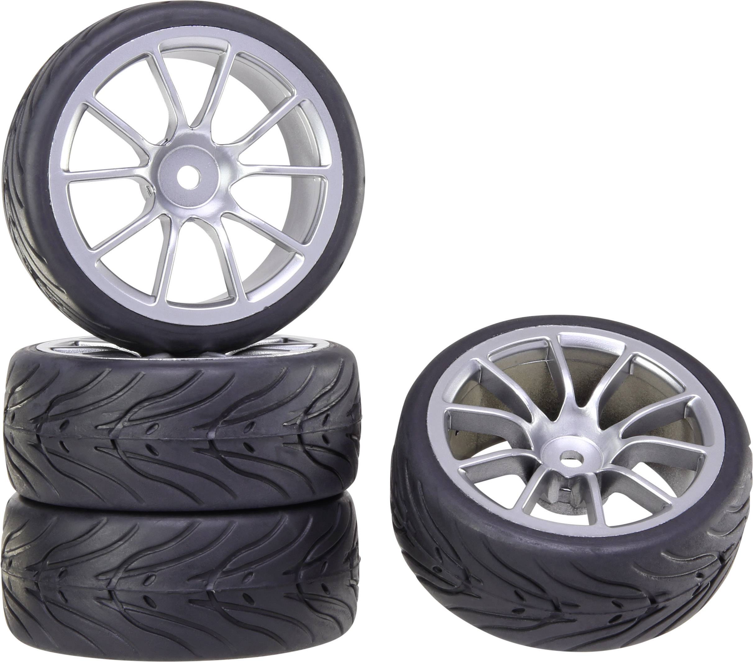 'Three racing tyres stacked on top of each other with a fourth tyre placed on top. They have silver rims and a sporty tread pattern.'