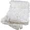 A folded, white shower curtain with floral fabric decorations and visible hanging strings lies on a pile.