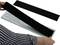 A person is attaching a black hook-and-loop fastener to a number plate holder.
