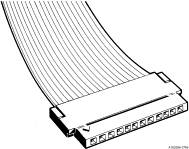 Flat ribbon cable with a connector, used for electronic connections. Several parallel conductors are visible on the left.