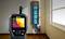 A moisture measuring device displays thermal imaging data in a room. Next to a window, there is a glowing arrow with the inscription 'Look HERE'.
