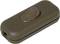 A brown toggle switch for lamps, vertical orientation, with a central rocker, suitable for controlling electrical devices.