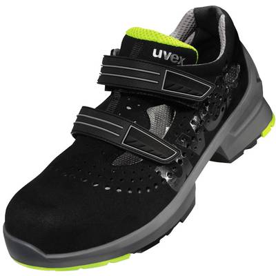 A black safety shoe with two hook and loop fasteners and a green sole. Upper material features perforated details for breathability.