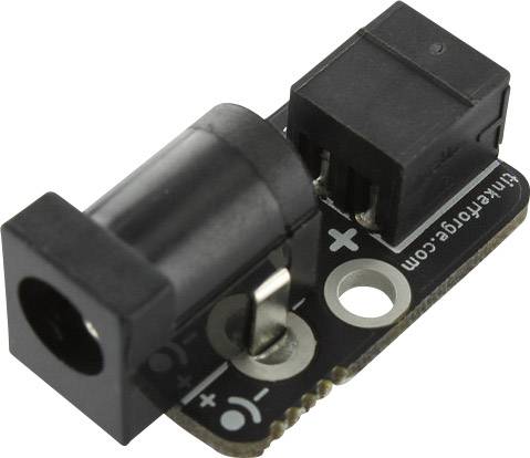 Small electronic component with a black plastic casing, two sockets, and printed '+' and '-' symbols for power connections.