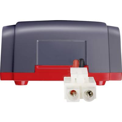 A grey electronic device with red elements and white connection terminals is positioned centrally in the image.