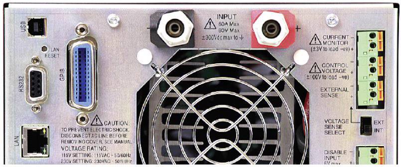 Back of an electronic device with power and control connections, a fan, and multiple socket ports for various connections.
