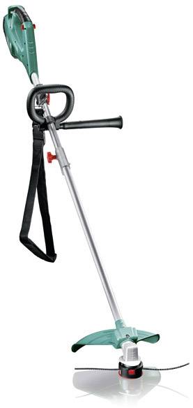 Green electric lawn trimmer with long handle, shoulder strap, protective shield, and rotating cutting blade on the underside.