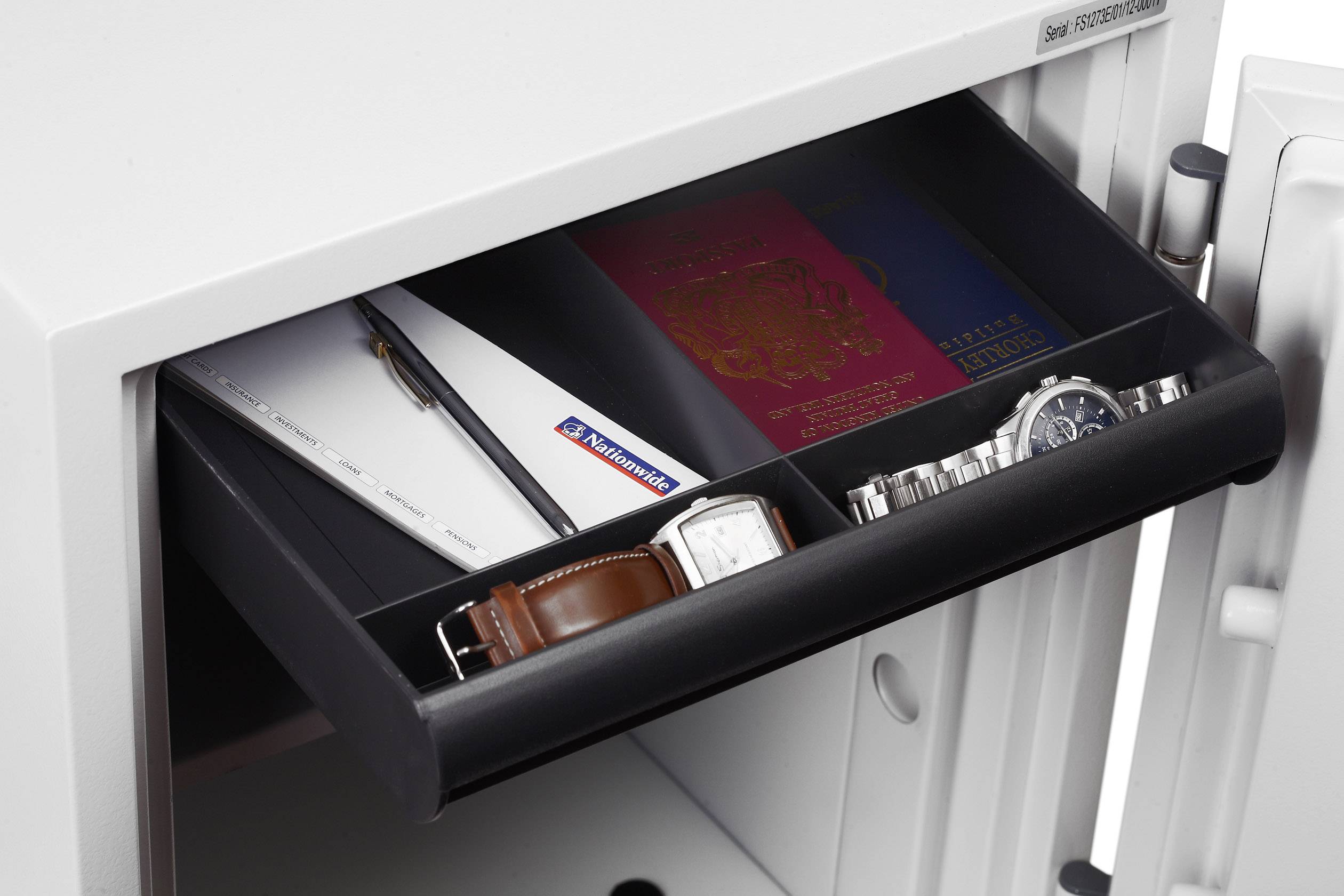 Opened safe with a compartment containing a passport, watch, pen, and documents.
