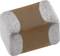 A small, rectangular SMD capacitor with metallic ends and a brown ceramic body, used in electronic devices.