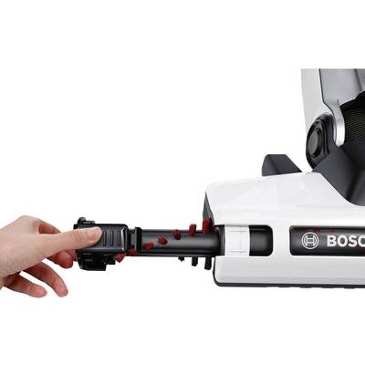 'Hand presses red brush attachment into white Bosch vacuum cleaner.'