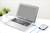 A laptop is connected to an external hard drive. Two plants are standing on the table. The laptop screen is on.