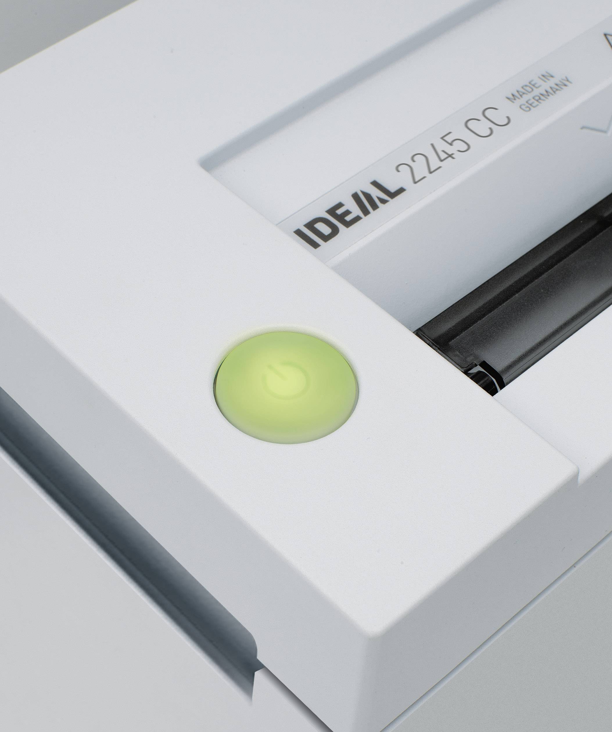 A paper shredder in close proximity with a bright green on/off switch and text reading 'IDEAL 2245 CC Made in Germany'.