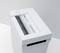 Paper shredder in operation: A sheet of paper is being pulled through the slot. The shredder has a simple, modern design.