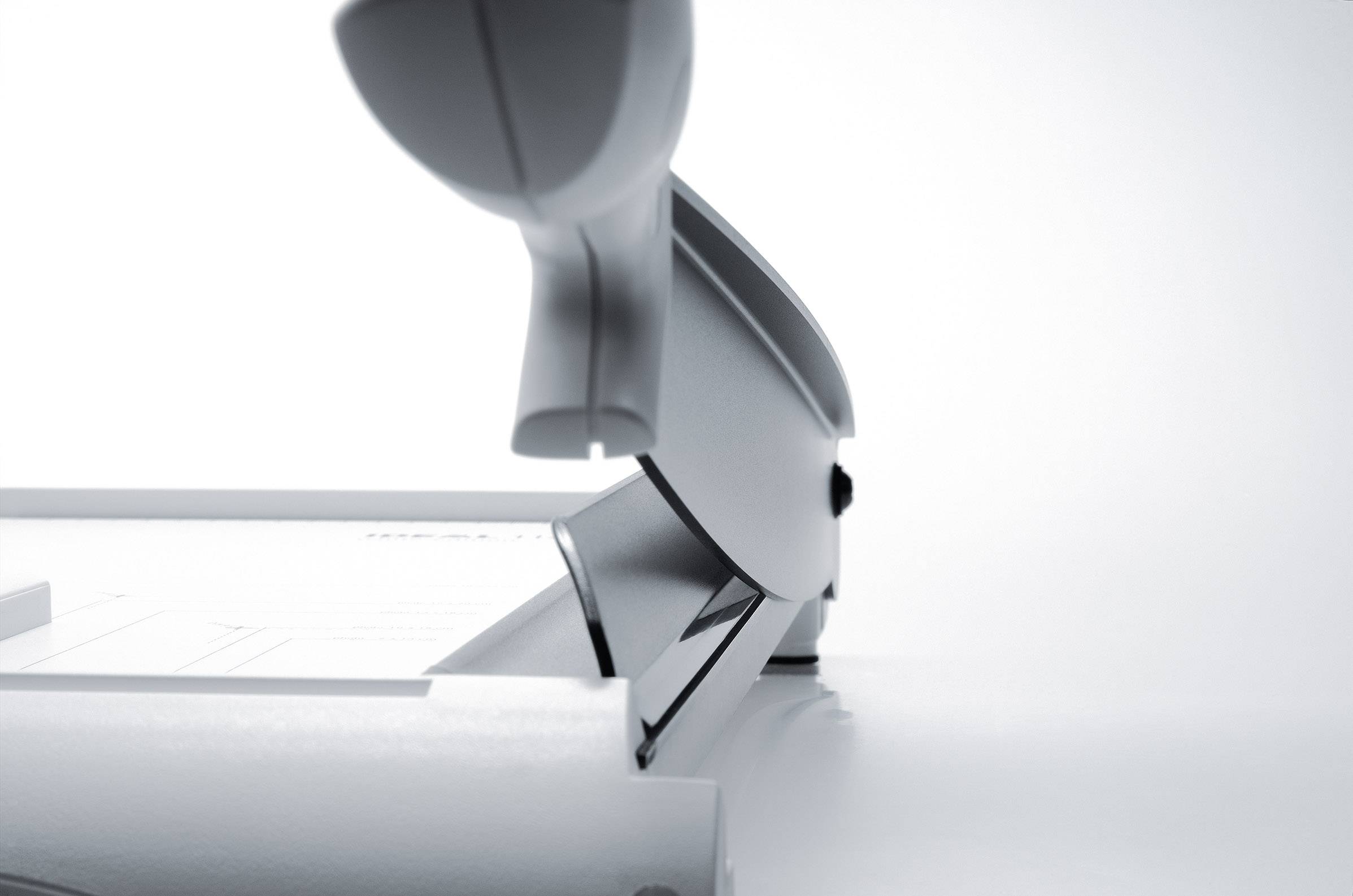 A modern stapler in close-up, showing the metal staples clearly and emphasising the device's simple, elegant design.