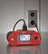 A red installation measuring device is plugged into a socket and displaying measurement readings on its display.