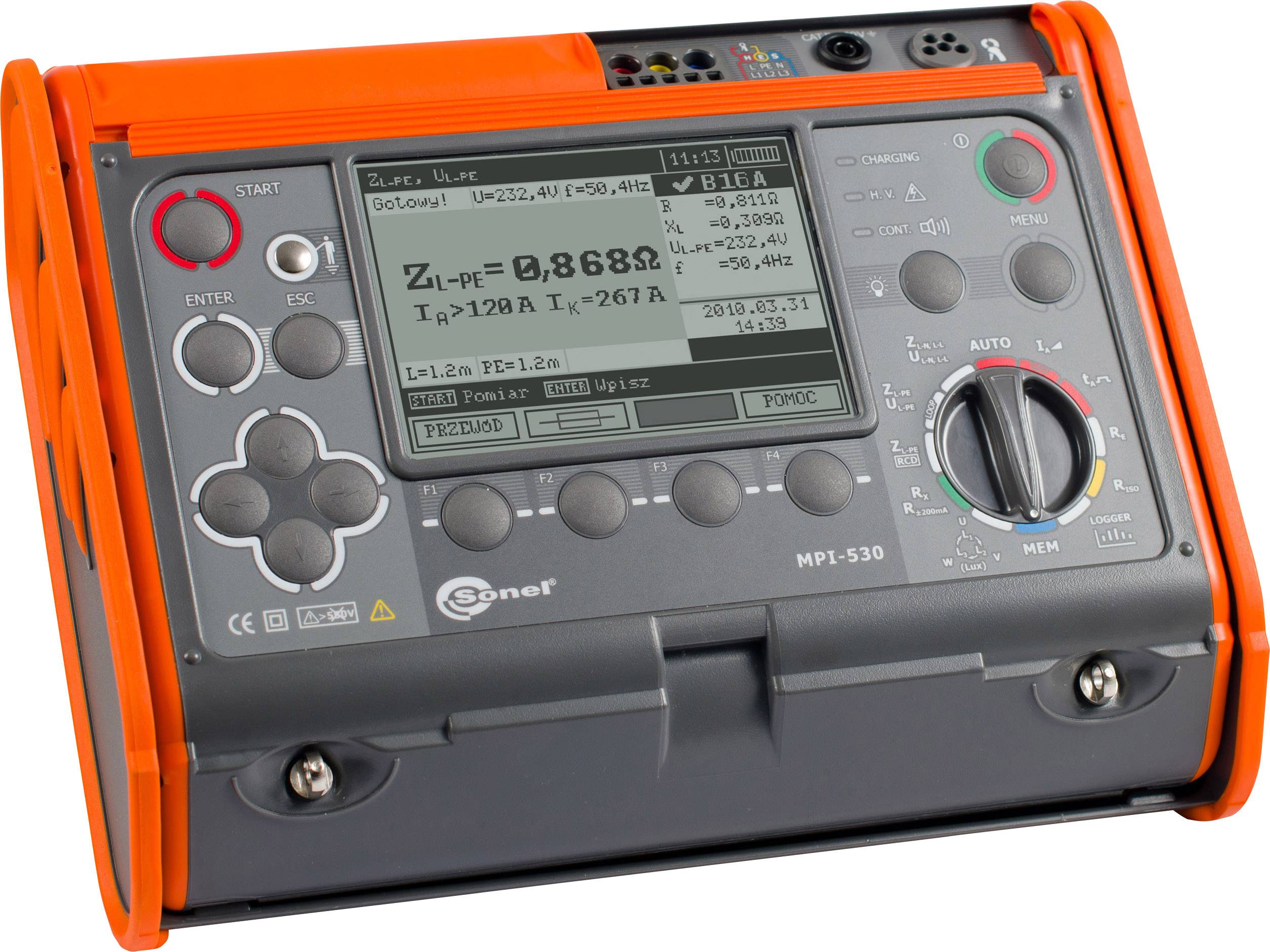 An orange-grey electrical testing device with a display, showing measurement values and control buttons. Used for testing electrical installations.