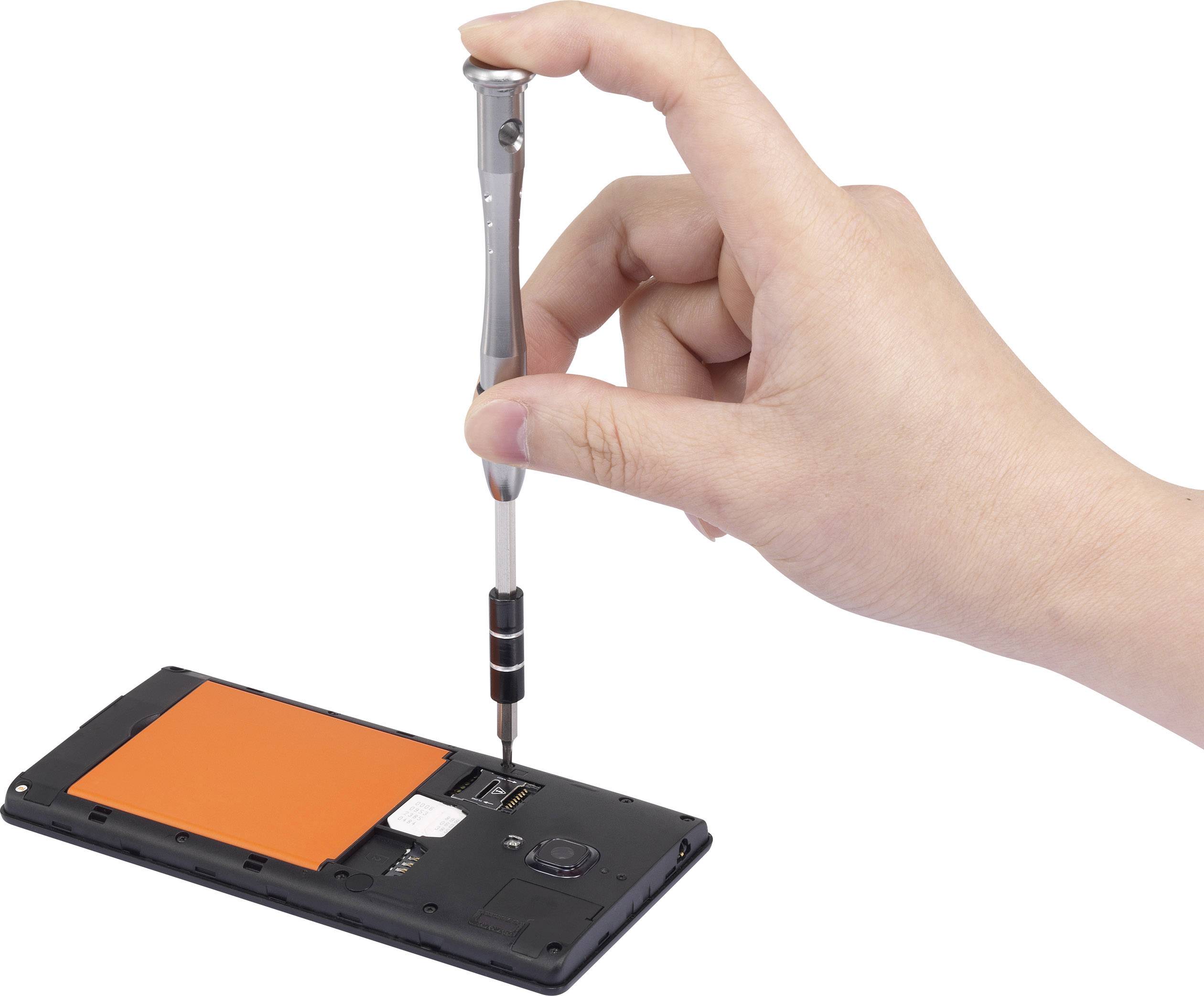 A hand holds a screwdriver and is undoing a screw on the back of an opened smartphone with an orange cover.