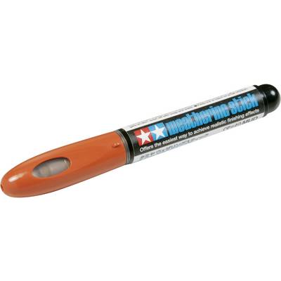An orange and black Tamiya weathering stick marker.