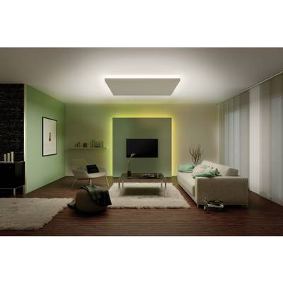 A modern living room with a sofa, coffee table, television mounted on the wall and stylish lamps. The walls are green and white.
