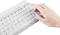 A hand presses an 'Enter' key on a white computer keyboard.