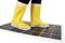 A person wearing yellow wellington boots is standing on a solar panel.