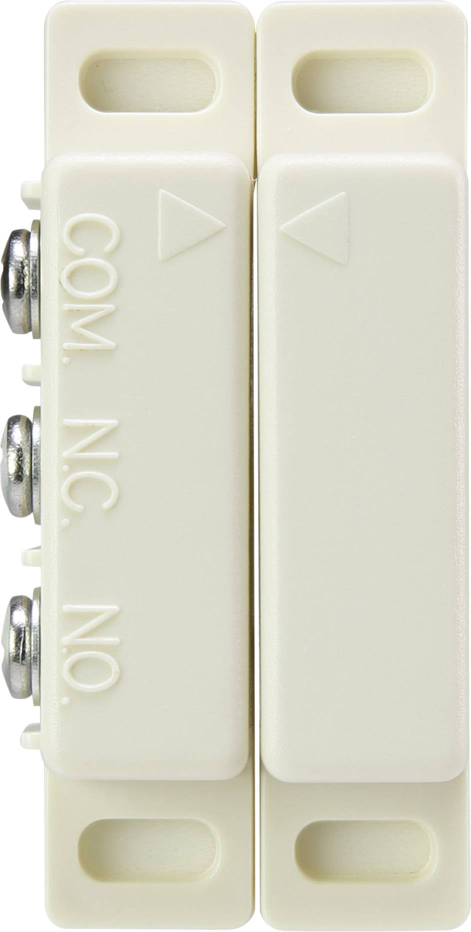 A cream-coloured magnetic sensor with two raised triangular symbols and labels 'COM', 'NC', 'NO' on the side with screw terminals.