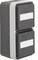 Double light switch on a white wall, grey casing with rectangular toggles, each with a white labelling field.