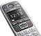 Portable cordless telephone with digital display showing time as 12:13. Buttons for telephoning, menu and navigation visible.