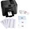 A black printer is printing address labels. Beside it are printed label sheets, greetings cards, and envelopes with names and addresses.