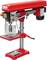 A red bench drill with a drill head, adjustable metal table and lever, suitable for precise drilling in workpieces.