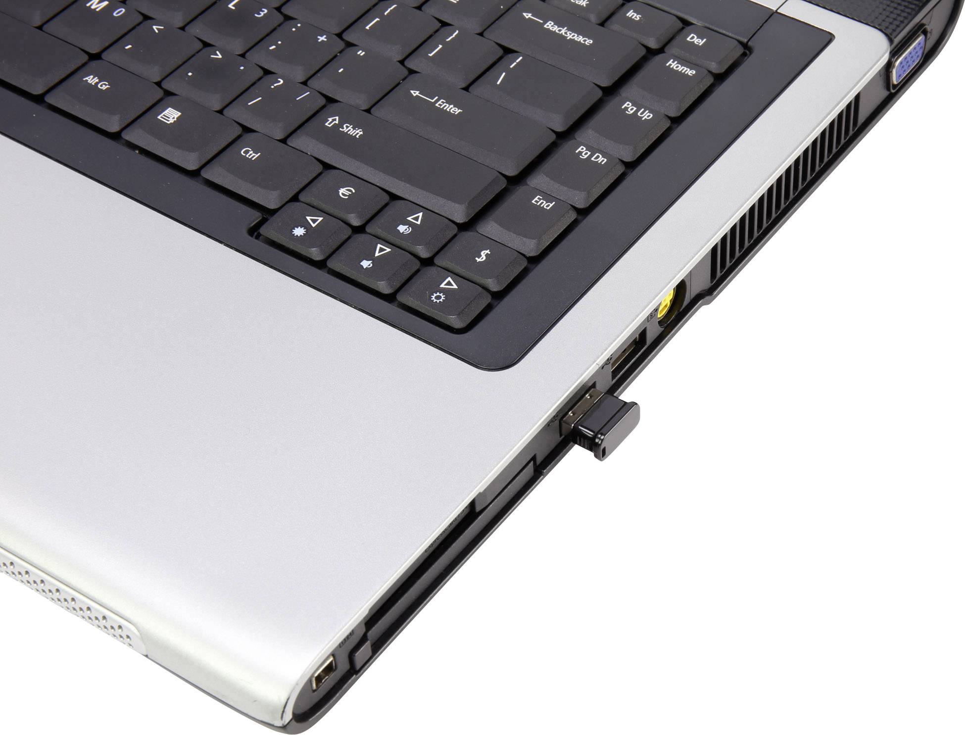 A laptop with a black keyboard. A USB stick is plugged into the side of the laptop.