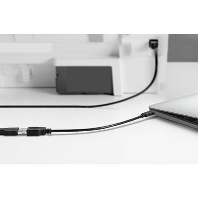 A laptop is connected to a printer via a USB cable.