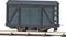 A dark green model goods wagon is positioned on a section of track. It has two doors and black detailing.