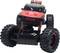 A red and black toy car with large tyres and shock absorbers, pictured from the front.