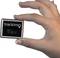 A hand is holding a small square device with the inscription 'Trackimo' and a button marked 'SOS'.