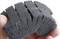 A dark grey, textured sponge is being held in the hand, likely for cleaning or polishing purposes.