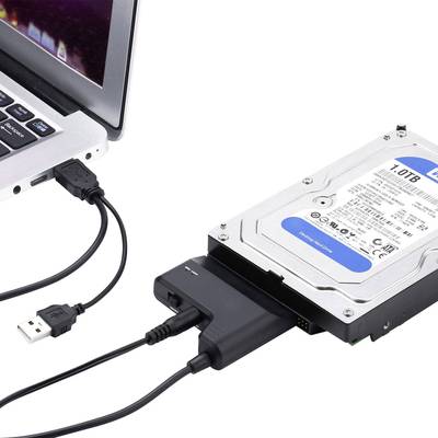 An external hard drive is connected to a laptop via a USB cable.