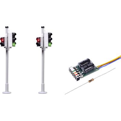Two model railway traffic lights with red and green illuminating lights. Beside them on the right lies a small electronic circuit with cables and a resistor.