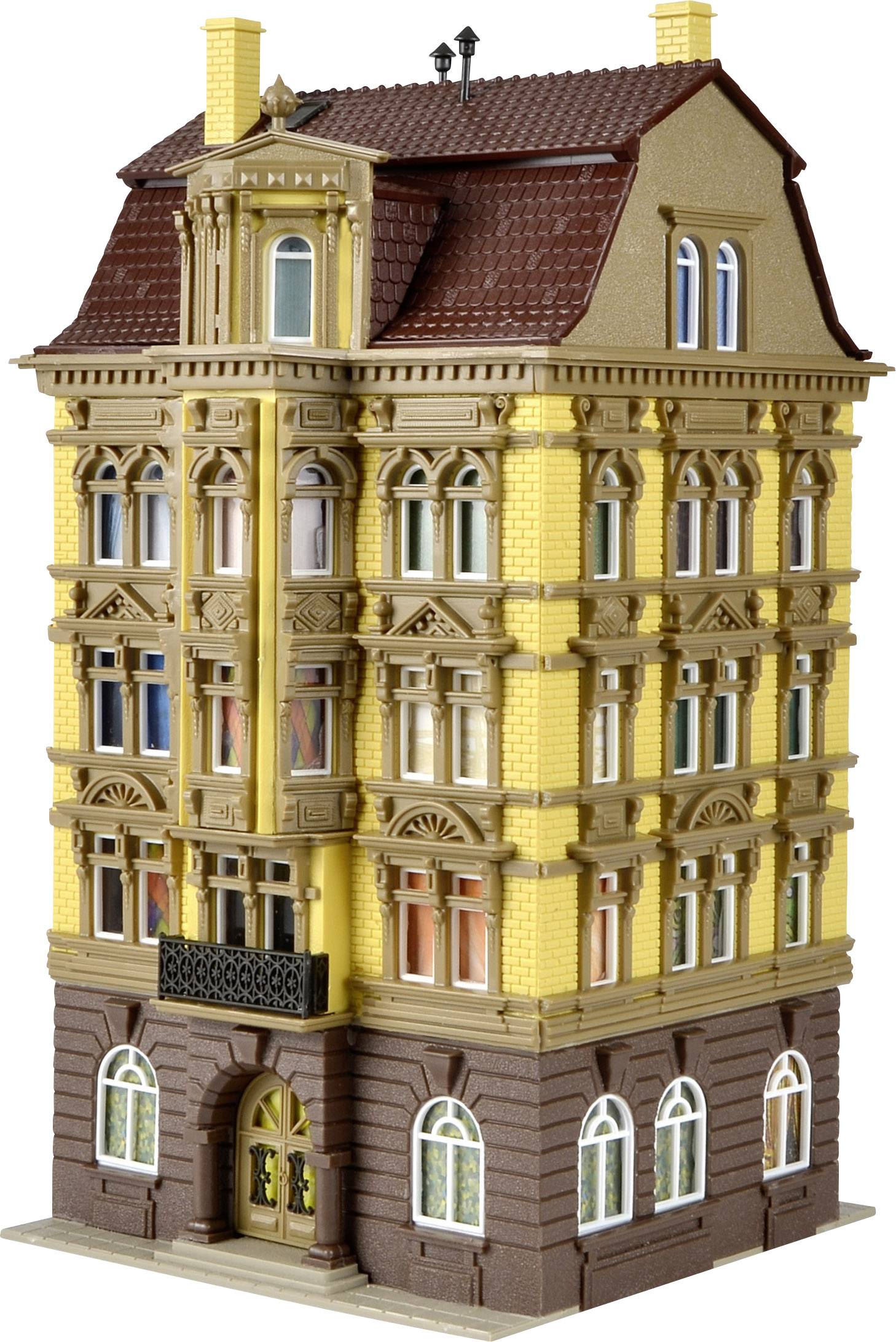 A historic, multi-storey building with elaborate ornaments and a red tiled roof. The façade is yellow with brown details.