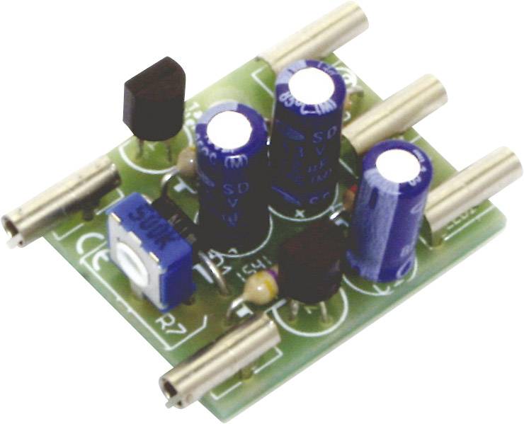 Small green electronic circuit board with blue capacitors and resistors, featuring several metallic connections.